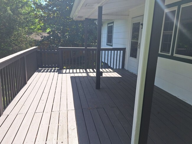 Building Photo - Cute white cottage with white picket fence & Huge deck off back door!