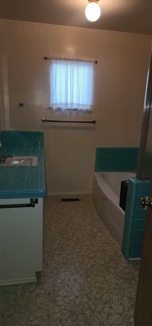 Building Photo - This is a spacious house featuring four bedrooms and two bathrooms, along with a two-car garage.