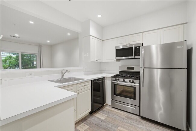 Building Photo - Commuter’s Paradise! Ground-Level 2BR Condo  Welcome home to this stunning, sun-filled 2-bedroom ...