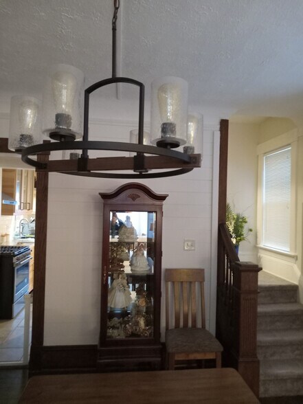 dining room light fixture, stairs to 2nd level, doorway to kitchen, shiplap accent wall - 1448 Lincoln Ave