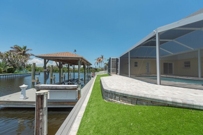 Building Photo - Live the ultimate Space Coast waterfront lifestyle at this stunning beachside canal home in Satel...