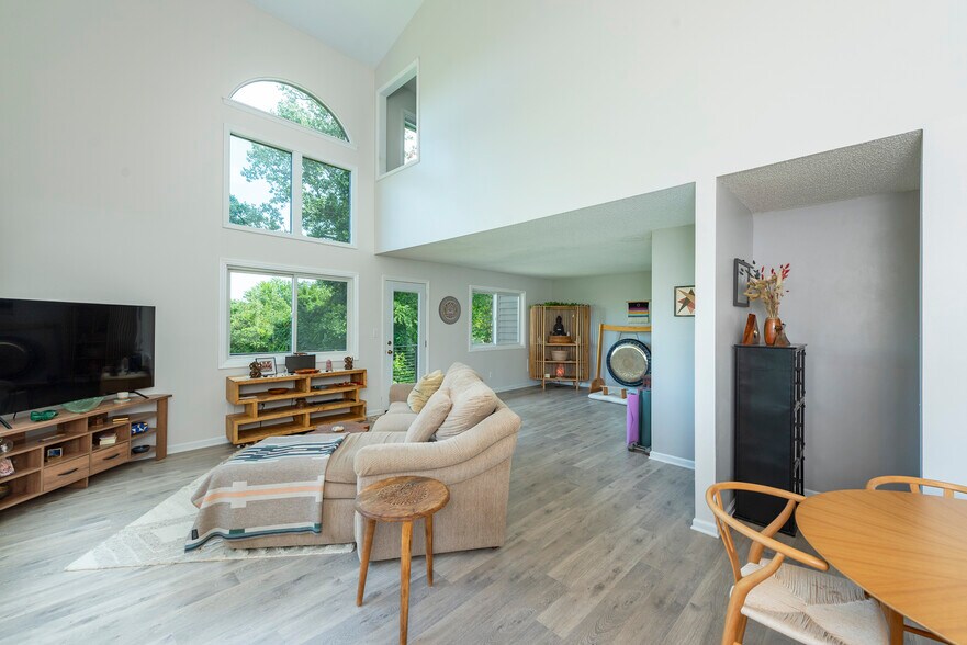 Bright and airy multi-level layout showcasing dramatic floor-to-ceiling windows, dual living zones. - 405 Windswept Dr
