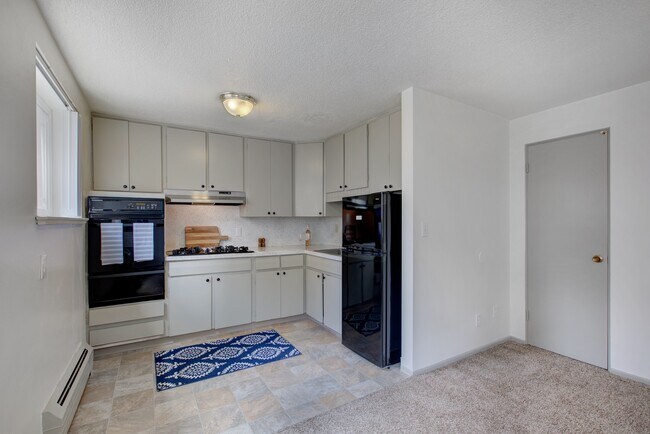 Experience the elegance of this bright and modern kitchen, perfect for culinary enthusiasts. - Harmony Apartments