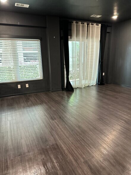 Open Living room and sliding glass doors to patio. - 4361 S Congress Ave