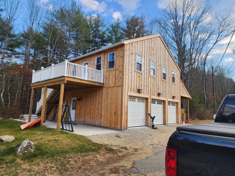 View of included deck and covered parking spot - 57 River Rd