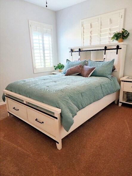 Guest bedroom with queen size bed & under storage drawers - 280 E Indigo Dr