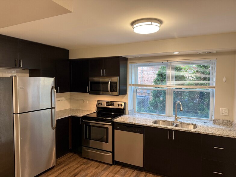 New kitchen with SS appliances and Granit cou - 6626 W Devon Ave