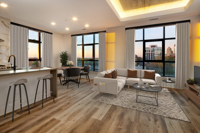 Kitchen, living, and dining areas with hard surface flooring throughout and floor-to-ceiling windows - Avalon Hawk