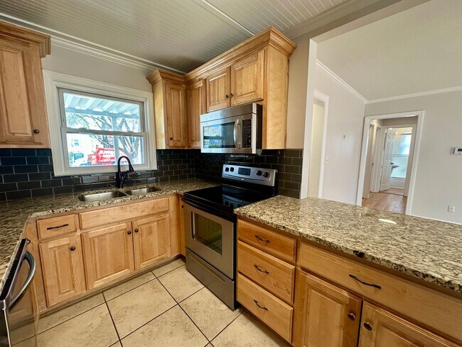 Building Photo - {5221} Updated Prairie Village Ranch + Fenced Yard + One Car Garage