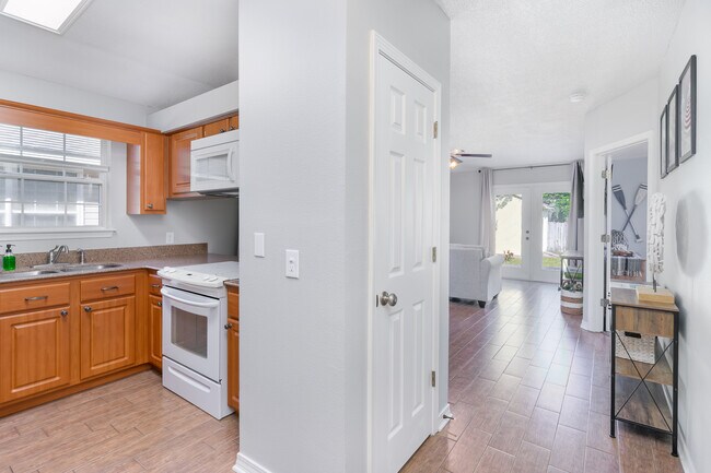 The open floor plan allows the visibility of the dining room and the living room from the kitchen. - 6464 Starfish Cv