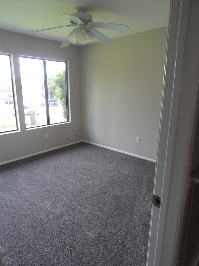 Building Photo - Two Story 4 BR 2.5 BA Condo With 2 Car Garage