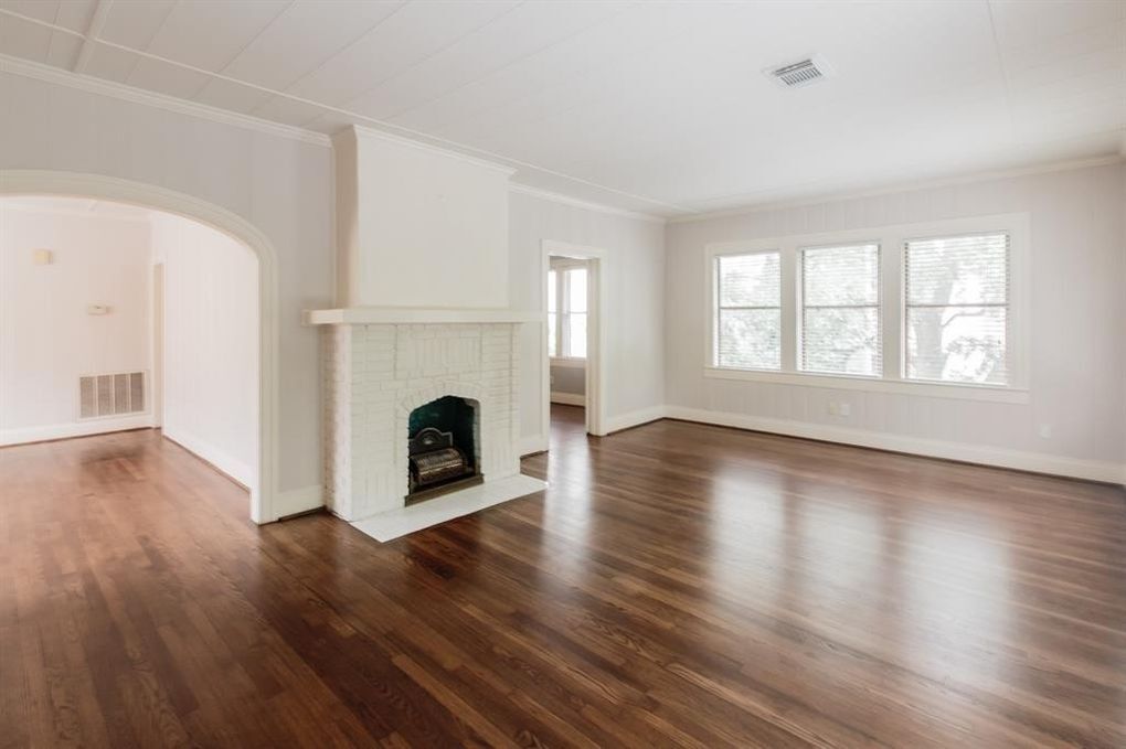 living room with fireplace and entry to dining area and bedroom - 1212 Milford St