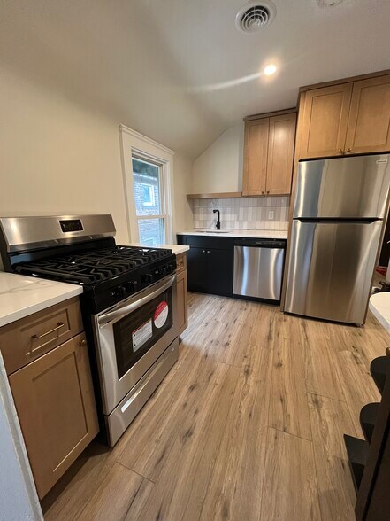 Kitchen includes newly installed cabinets, counters, and appliances - 1382 E 43rd St