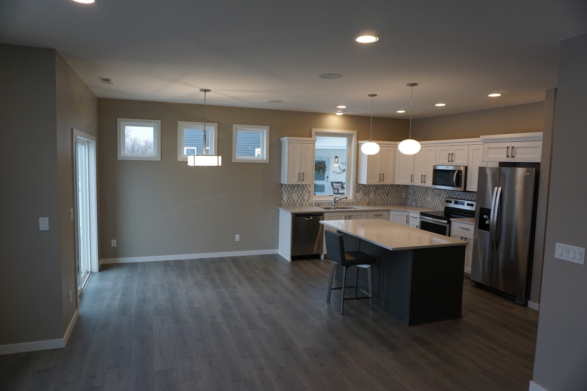 Grand living space open to kitchen (Photos are of similar unit with similar finishes.) - 3811 Stacy Drive
