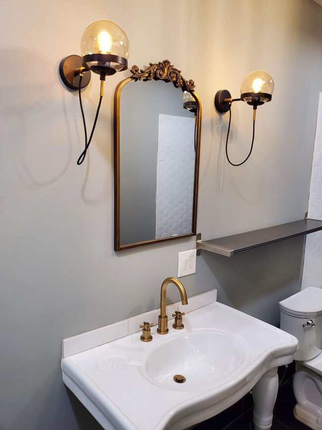 Vanity with signature faucet and light fixtures - 579 W. 13th St