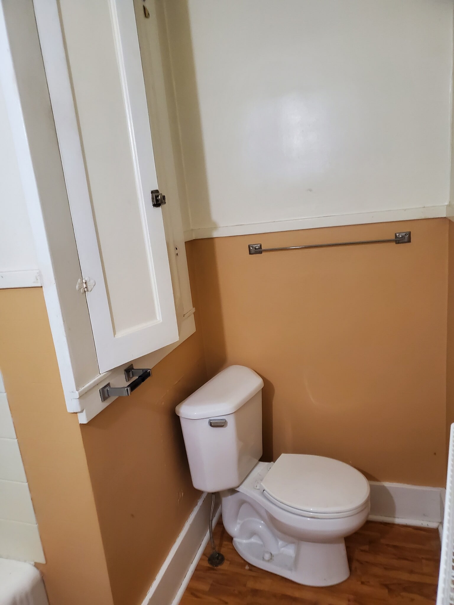 toilet with cupboards above - 606 7th St N