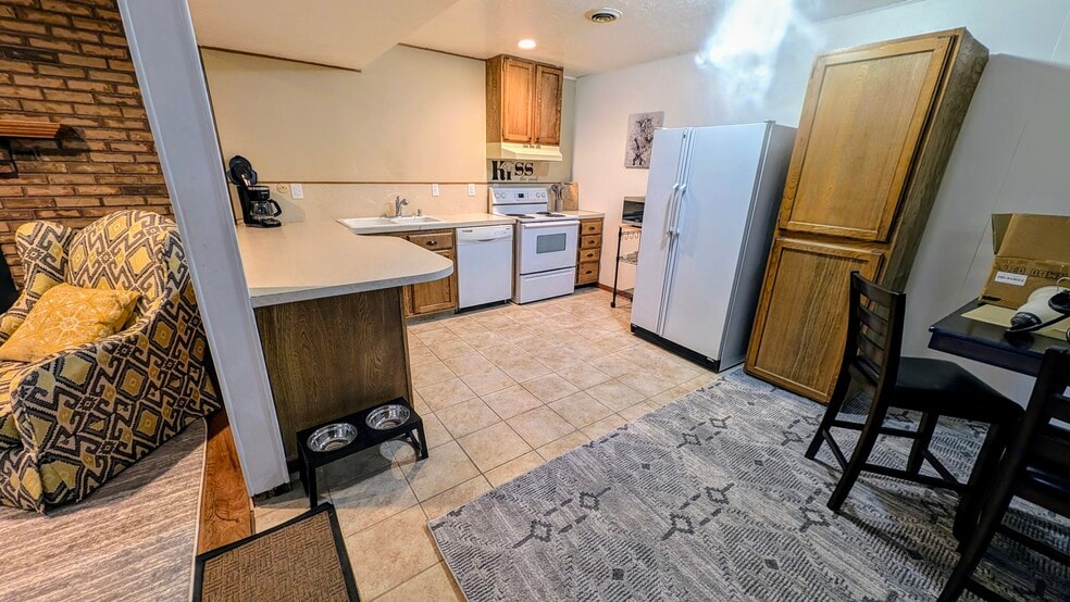 Kitchen with dishwasher, microwave and coffee maker - 495 N Eccles Ave