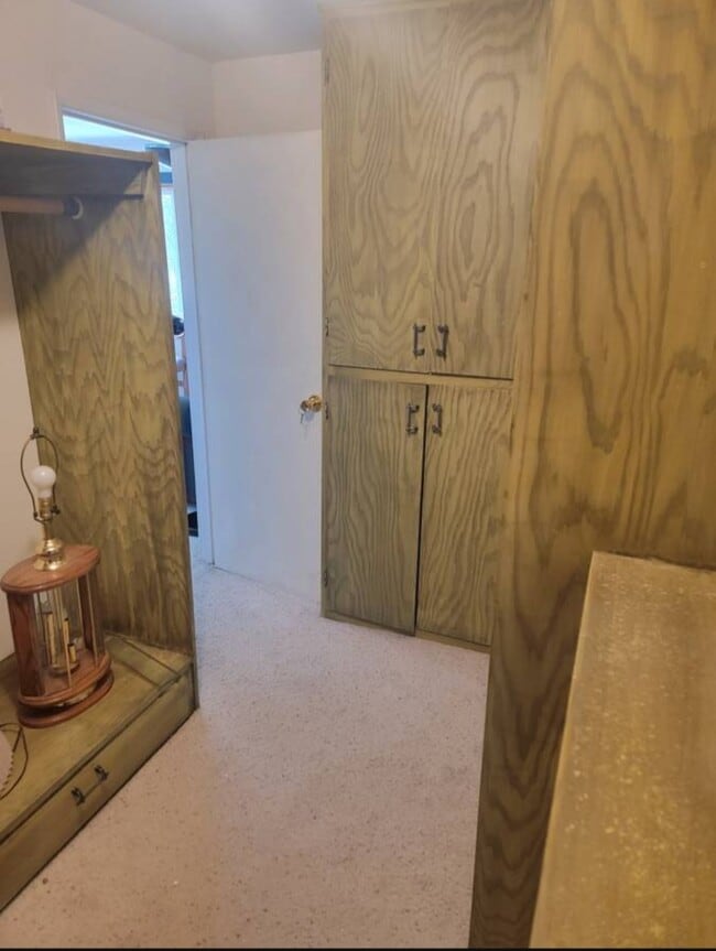 Pantry / closet has cabinets, shelves and clothes rods. - 16693 Sprague Loop