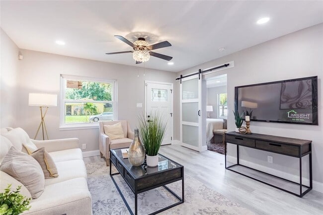 Living room with barn door to master suite - 1918 E Shadowlawn Ave