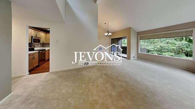 Building Photo - Top-floor 2-level condo with brand-new kit...