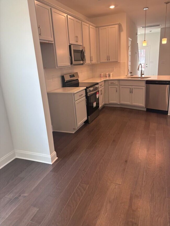 Building Photo - **BE THE LUCKY ONE TO LIVE IN THIS 2024-BUILT END-UNIT TOWNHOME IN A RESORT-STYLE COMMUNITY**