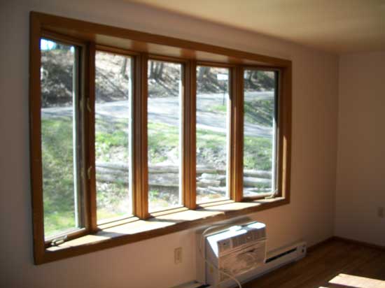 Large bay window in living room with blinds included. - 502 Mercer Rd