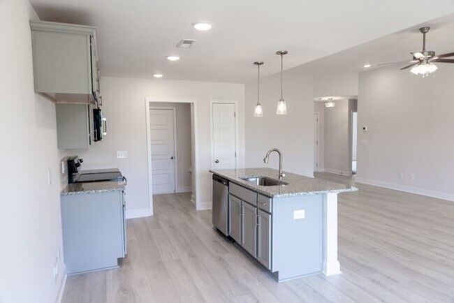 Building Photo - Modern Living Redefined with Stone Fireplace, Gray Cabinetry, Spa Inspired Primary Suite and Cove...