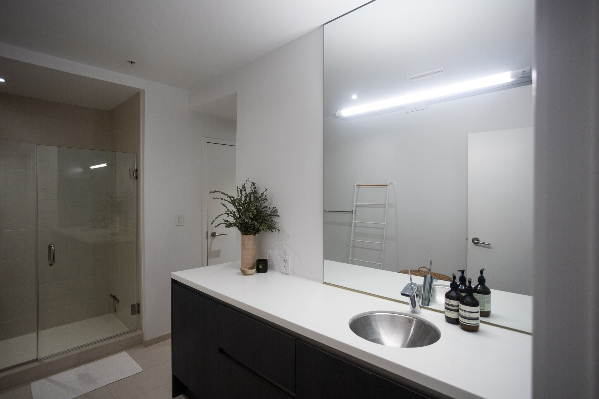 Modernist full bathroom with standing glass and tile shower. Ample counter space and vanity storage. - 2250 11th St NW