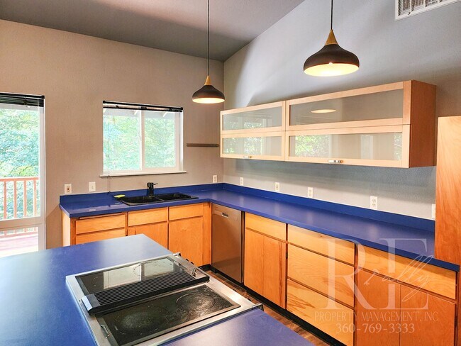 Building Photo - Vaulted Ceilings, Unique Designer Kitchen & Expansive Half-Acre Setting with Flexible Living Spaces