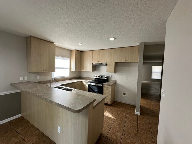 Kitchen with bar countertop - 208 W Tever St
