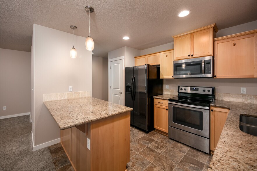kitchen with bar and room for stools - 1295 Windsong Dr