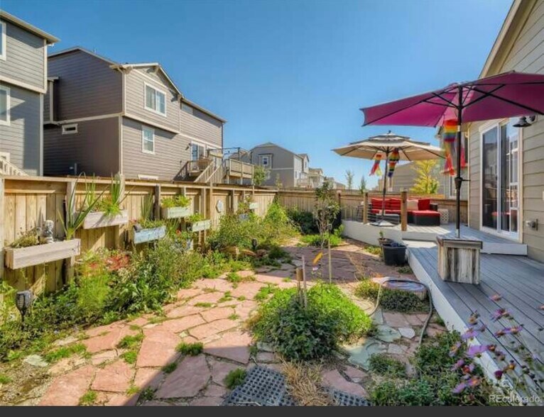 Established back yard with locked gates fence and deck - 9260 Rifle St