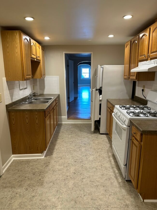 Kitchen towards living room. Laundry room at left in kitchen. - 9686 Brewerton Rd