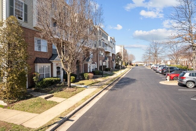 Building Photo - This inviting two-level townhome offers comfort and style, featuring gleaming hardwood floors on ...