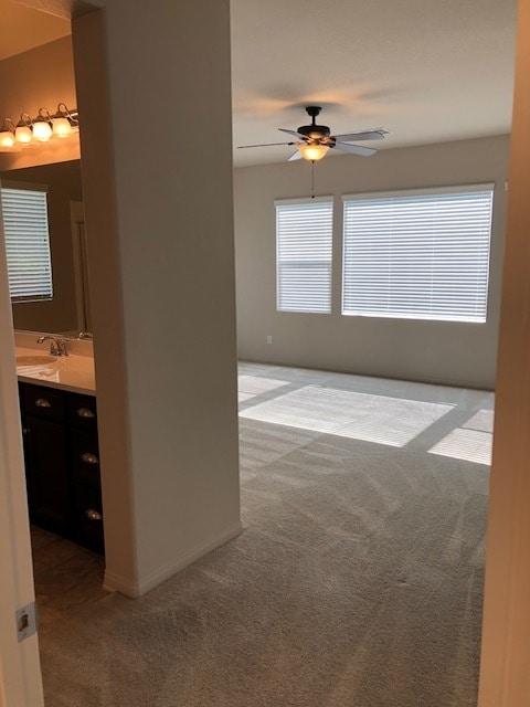 Master bedroom with ceiling fan and attached bathroome - 30426 Cowboy Ln