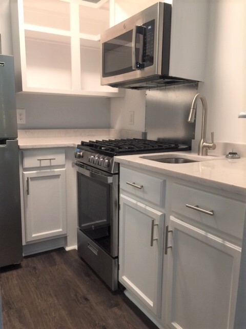 This studio kitchen has granite countertops and a stainless steel sink, as well as cubbies, cabinets and drawers for storage. - 3819 Gallatin Pike