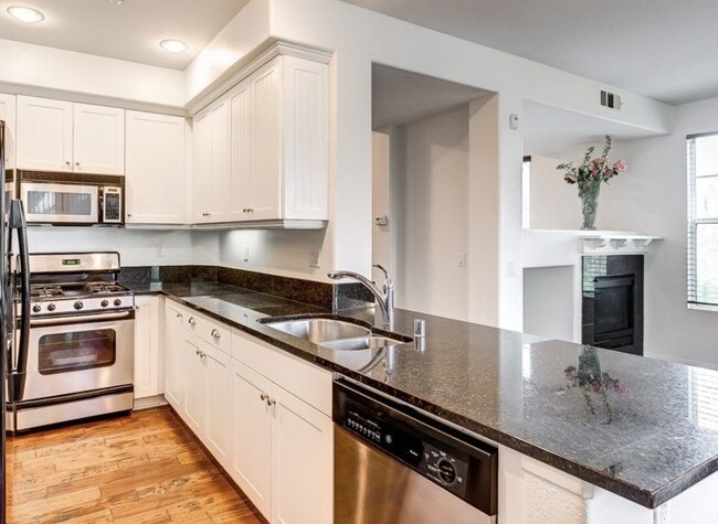 Granite counters with beach-y look cupboards - 820 Harbor Cliff Way