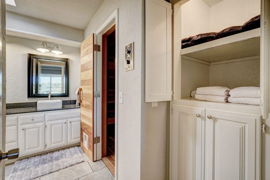 Master Suite Bathroom equipped with a Resort-Style Sauna (robes and towels available). - 3905 NW 70th St
