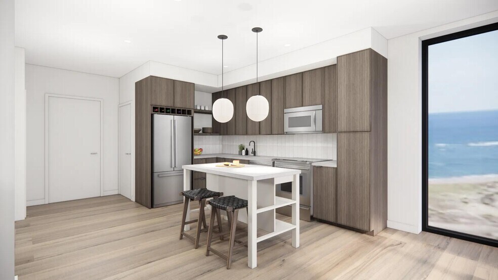 Gourmet kitchens with quartz countertops, custom cabinetry, and tile backsplash at Modera Revere Beach in Revere, MA. - Modera Revere Beach