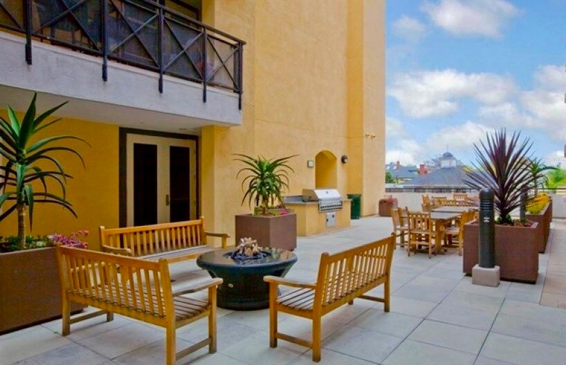 Outdoor courtyard with firepit seating for evening relaxation. - 3687 4th Ave