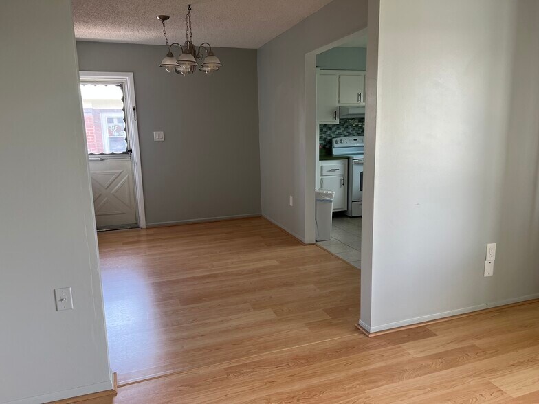Looking toward adjoining dining room wirth 2nd exterior door to stairway leading to pool area. - 3535 41st Ter S