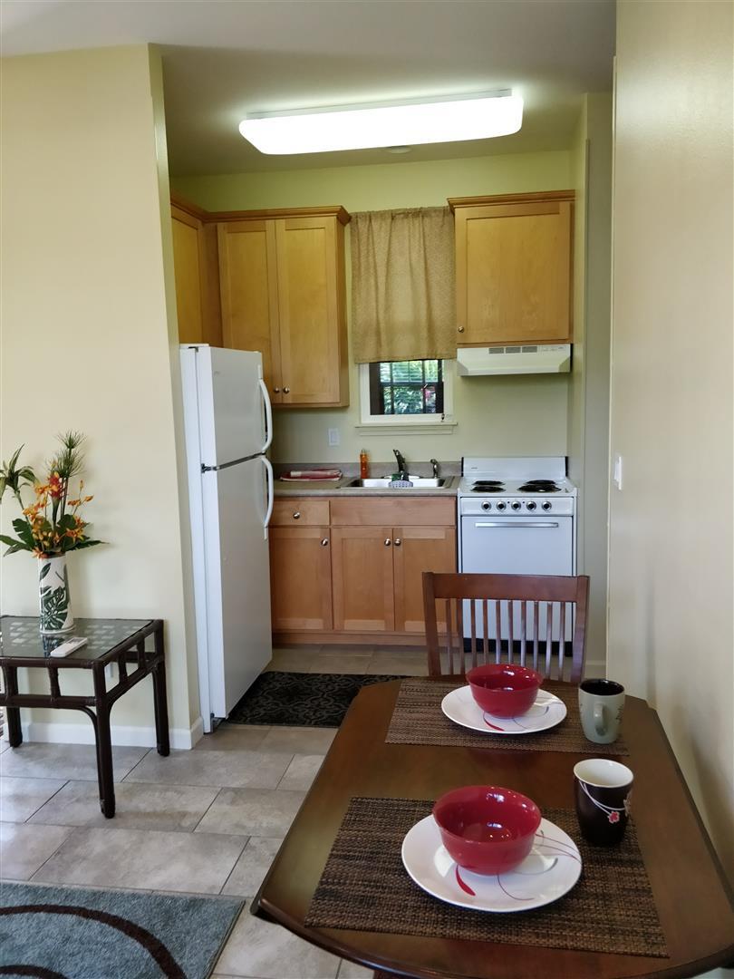 Dining + Kitchen area w/ new tile and area rugs; furnishing shown can be provided - 170 Kuli Puu St