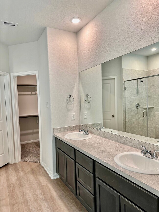 The primary bathroom features double sinks, plenty of storage and a walk-in closet! - 507 Turtle Dove Dr