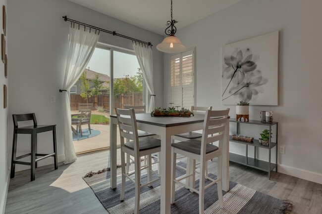 Smaller groups can enjoy dining at the high-top table, with a view of the backyard and quick kitchen - 1698 Gemtown Dr