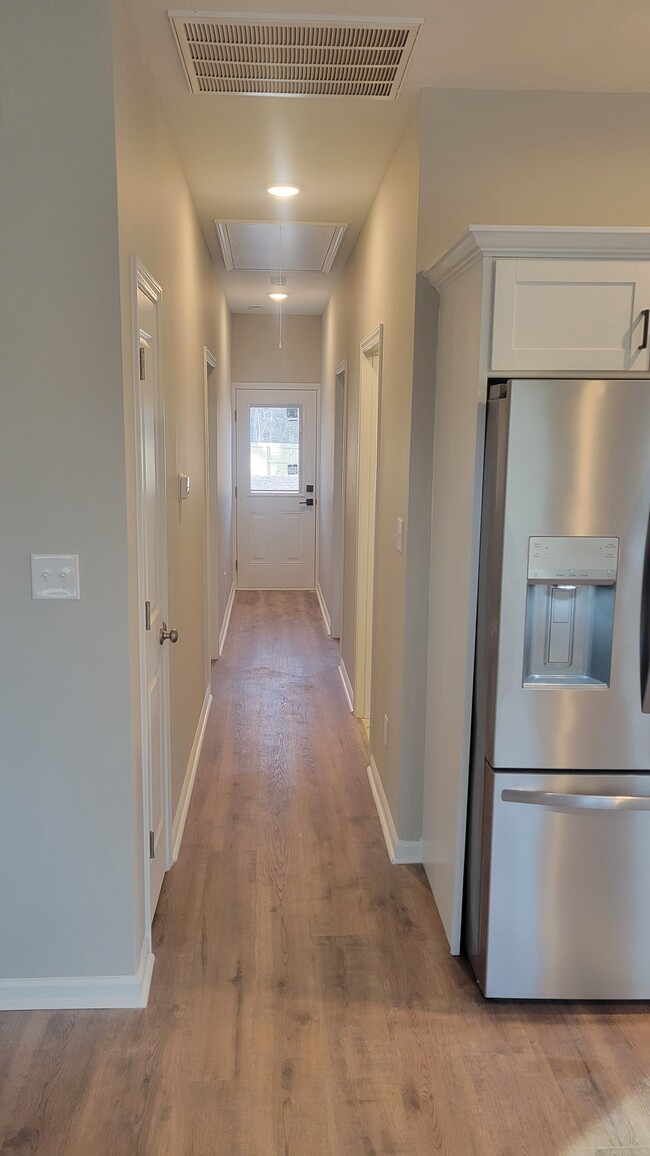 Hallway with linen closet and to back door and bedrooms and hall bathroom - 203 Payne St