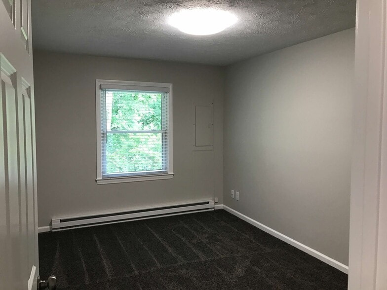Bedroom 2. Rear. Wooded view. - 874 A Pleasant Ridge Rd