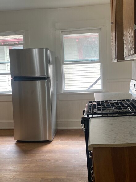 kitchen with new appliances and refinished floors - 2550 N 45th St
