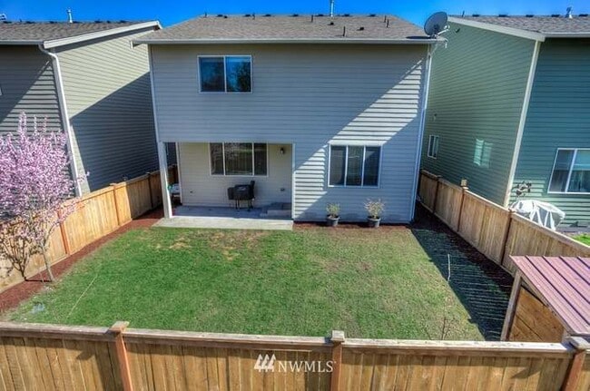 Backyard fully fenced, living room window on lower, masterbedrom upstairs, lower right dining left, - 8828 Jayden Ln NE