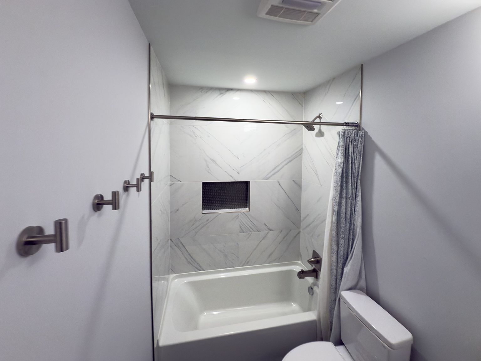 Tub/shower with marble tile surround and built-in storage niche - 2006 Candle Ct