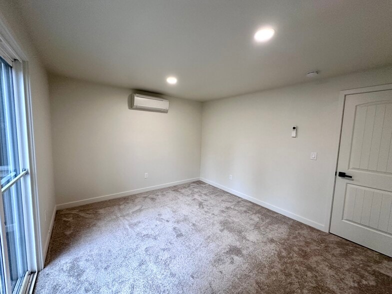 Bedroom 1 with a balcony, new carpet, paint, split - 1014 W 23rd St